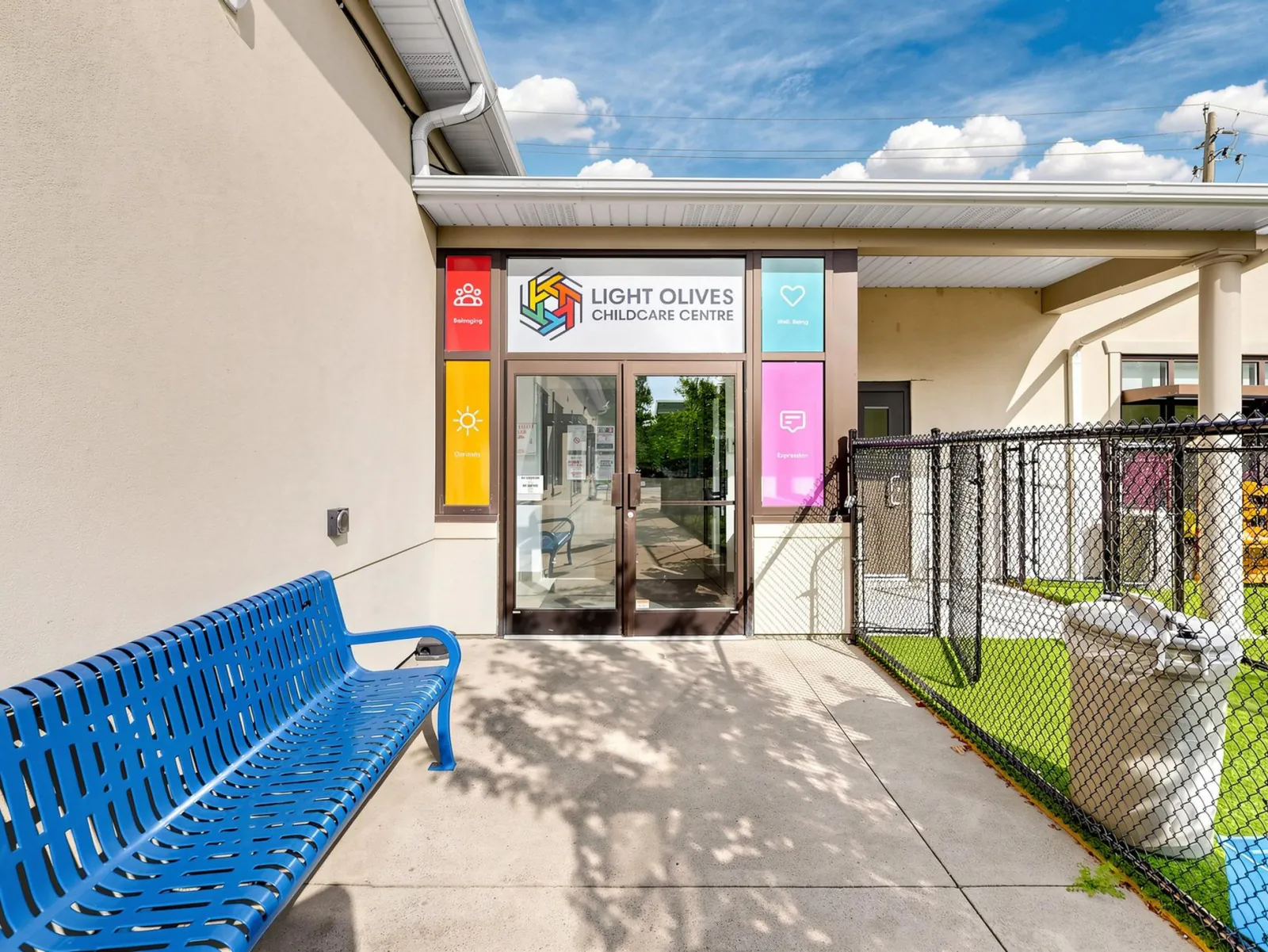 The welcome doors on King Street, with a bench for slow goodbyes.